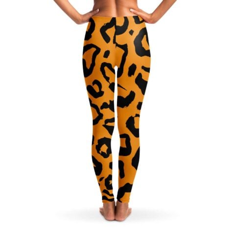 Back view of orange and black tiger stripe rave leggings with bold all-over stripes