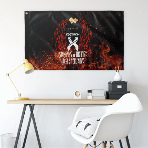 Black X logo flame rave flag hung on white wall above minimalist desk setup