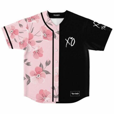 Flat lay front view of The Weeknd XO fan rave baseball jersey, split cherry blossom and black with XO text